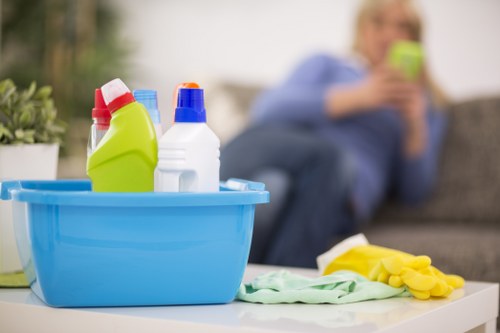 A person disinfecting a kitchen surface during regular cleaning
